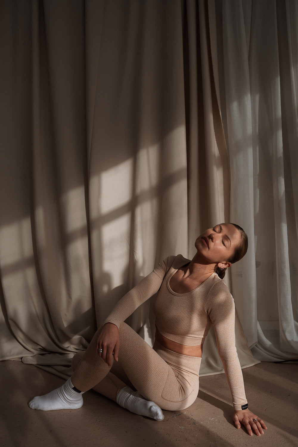 Sculpting ribbed sand coloured activewear crop top with long sleeves and matching leggings by Pine & Treasure.